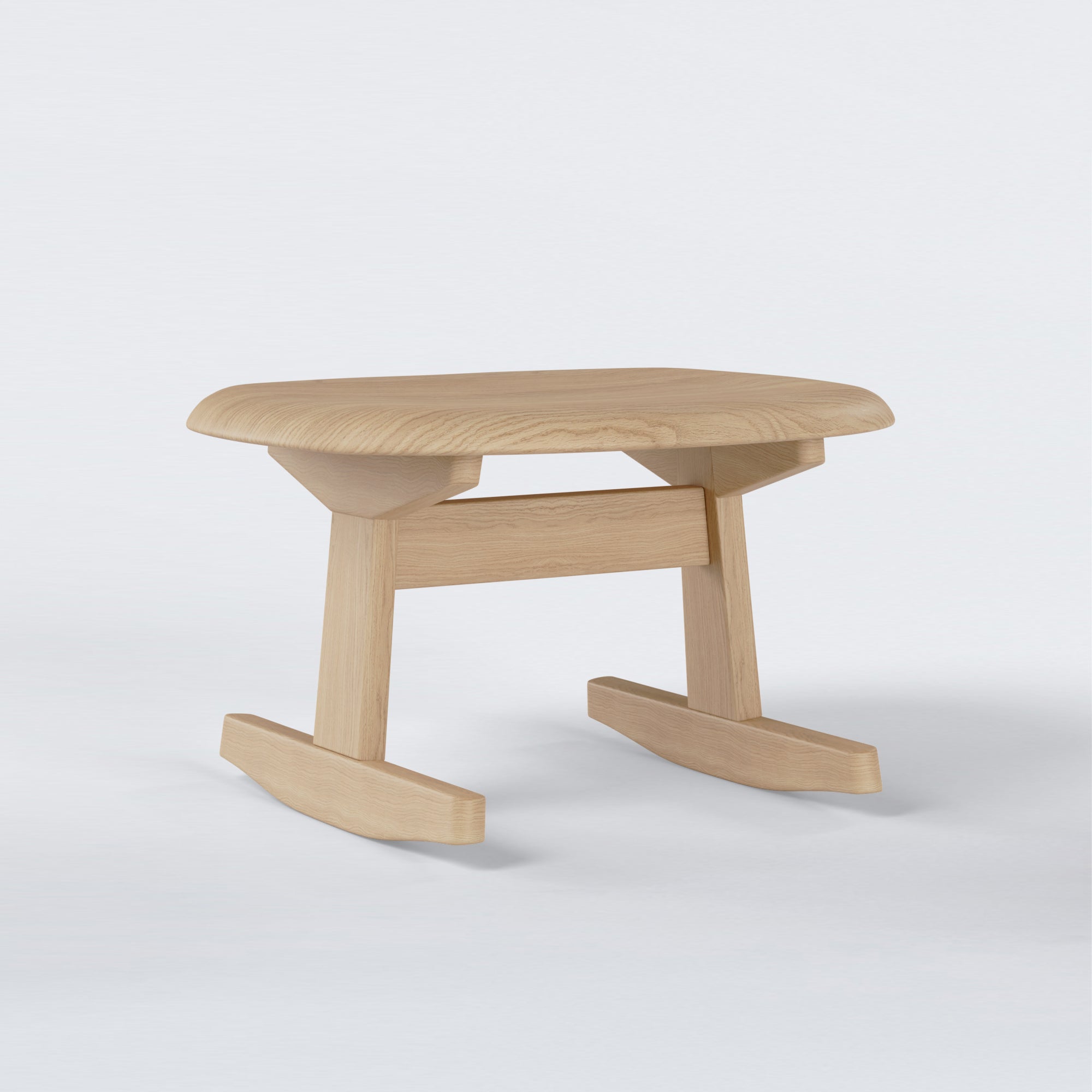 KufenKarl Rocking Ottoman in natural oak – angled view, showcasing the clean lines and subtle curves.